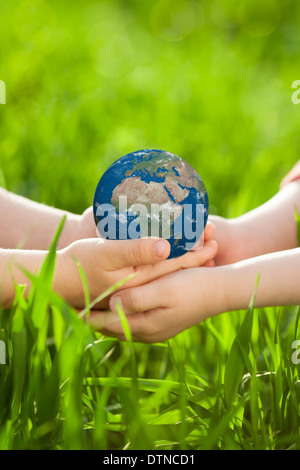 Earth in children`s hands Stock Photo